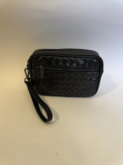 Black woven leather handbag with wrist strap and zipper pocket.