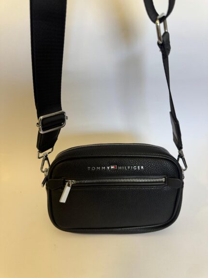 Black Tommy Hilfiger bag with adjustable strap and front zipper.