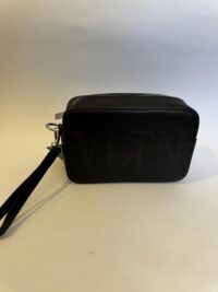Black Valentino VLTN bag with wrist strap, elegant and stylish design.