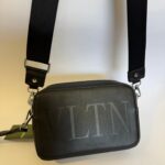 Black Valentino VLTN bag with adjustable strap, elegant and stylish design.