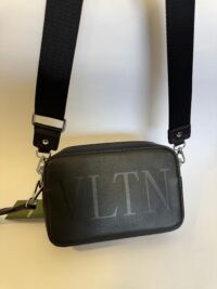 Black Valentino VLTN bag with adjustable strap, elegant and stylish design.