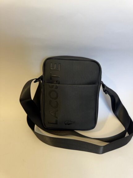 Black Lacoste men's crossbody bag with logo and adjustable strap.