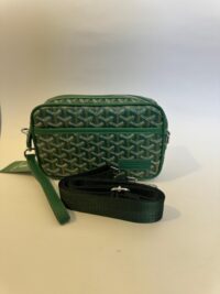Green Goyard crossbody bag with adjustable strap and signature pattern.