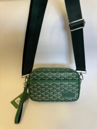 Green Goyard crossbody bag with adjustable strap and signature pattern.