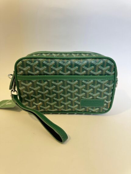 Green Goyard crossbody bag with signature pattern and wrist strap.