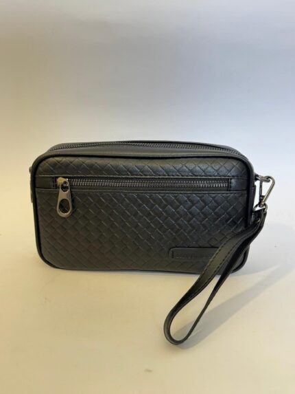 Elegant black wristlet clutch with textured design and zipper closure.